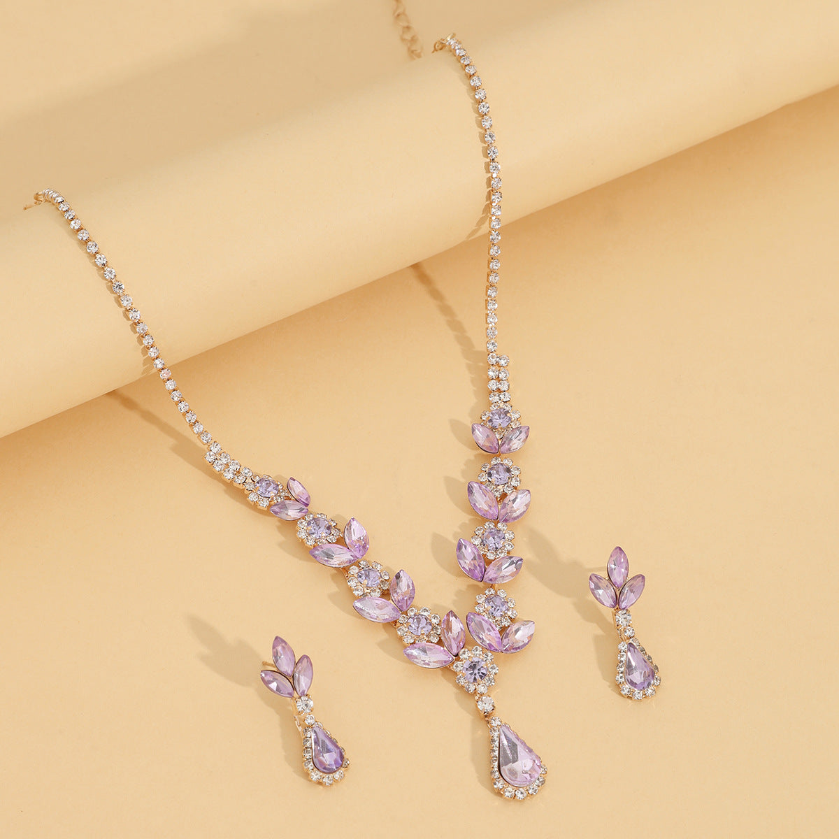 A fashionable set of purple flower necklaces, earrings and bracelets - perfect accessories for a bride's wedding party
