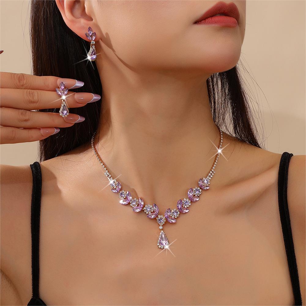 A fashionable set of purple flower necklaces, earrings and bracelets - perfect accessories for a bride's wedding party